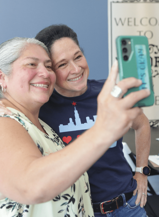 Susana Mendoza smiling into a phone camera with a constituent 