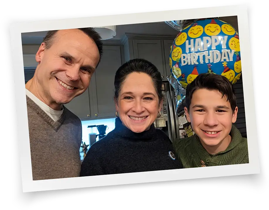 photo of Susana Mendoza with husband David Szostak and son David with a balloon that reads Happy Birthday